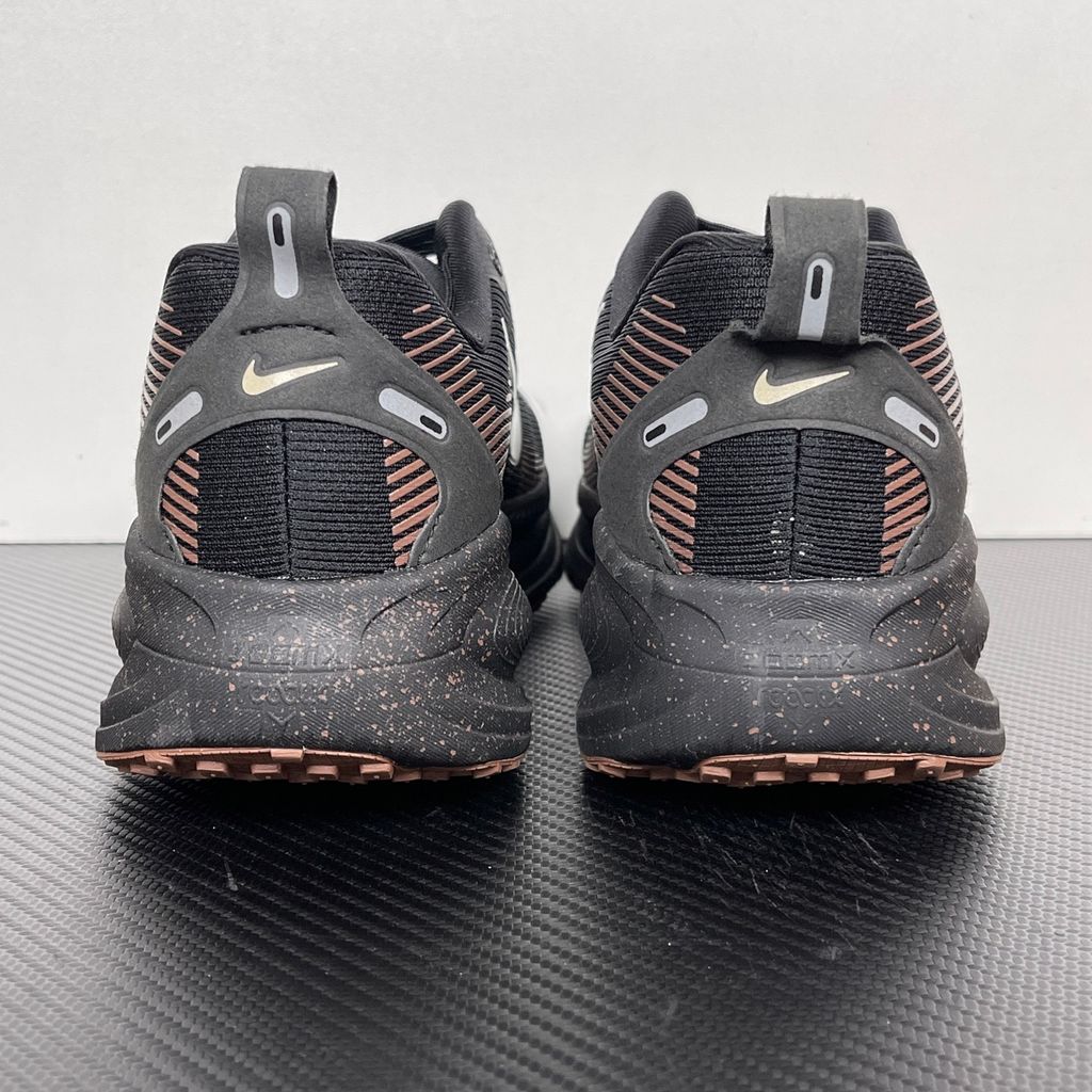 Side profile of the Nike Vomero 18 running shoe featuring a rich, tonal 'Coffee Bean' brown engineered mesh upper, subtle tonal Nike Swoosh branding, and a heavily cushioned, sculpted foam midsole.