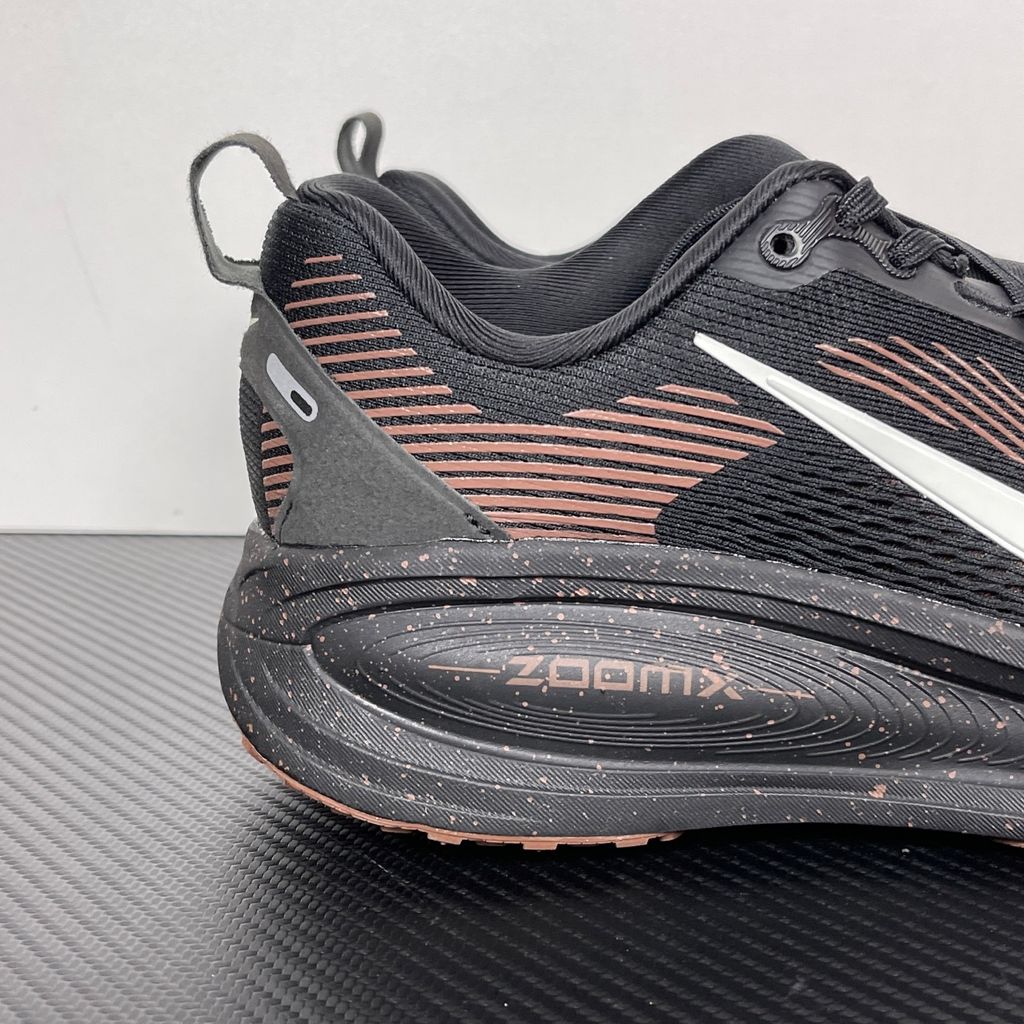 Side profile of the Nike Vomero 18 running shoe featuring a rich, tonal 'Coffee Bean' brown engineered mesh upper, subtle tonal Nike Swoosh branding, and a heavily cushioned, sculpted foam midsole.