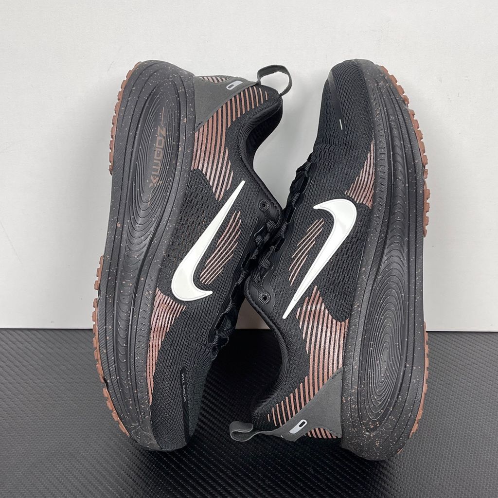 Side profile of the Nike Vomero 18 running shoe featuring a rich, tonal 'Coffee Bean' brown engineered mesh upper, subtle tonal Nike Swoosh branding, and a heavily cushioned, sculpted foam midsole.