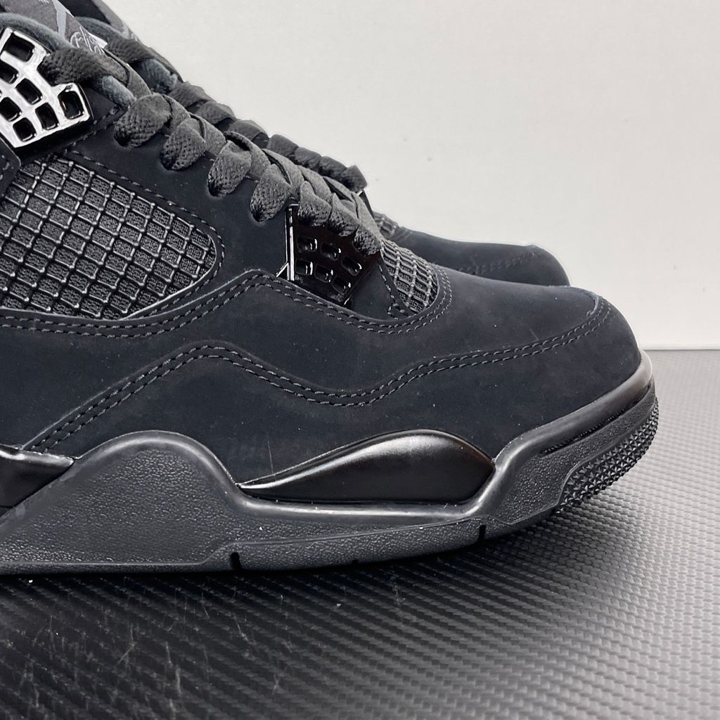 Side profile of the Air Jordan 4 Retro 'Black Cat' (2020) featuring a stealthy, monochromatic all-black nubuck suede upper, matching black mesh netting, matte wing eyelets, and a black midsole with a visible Air unit.  Product Description