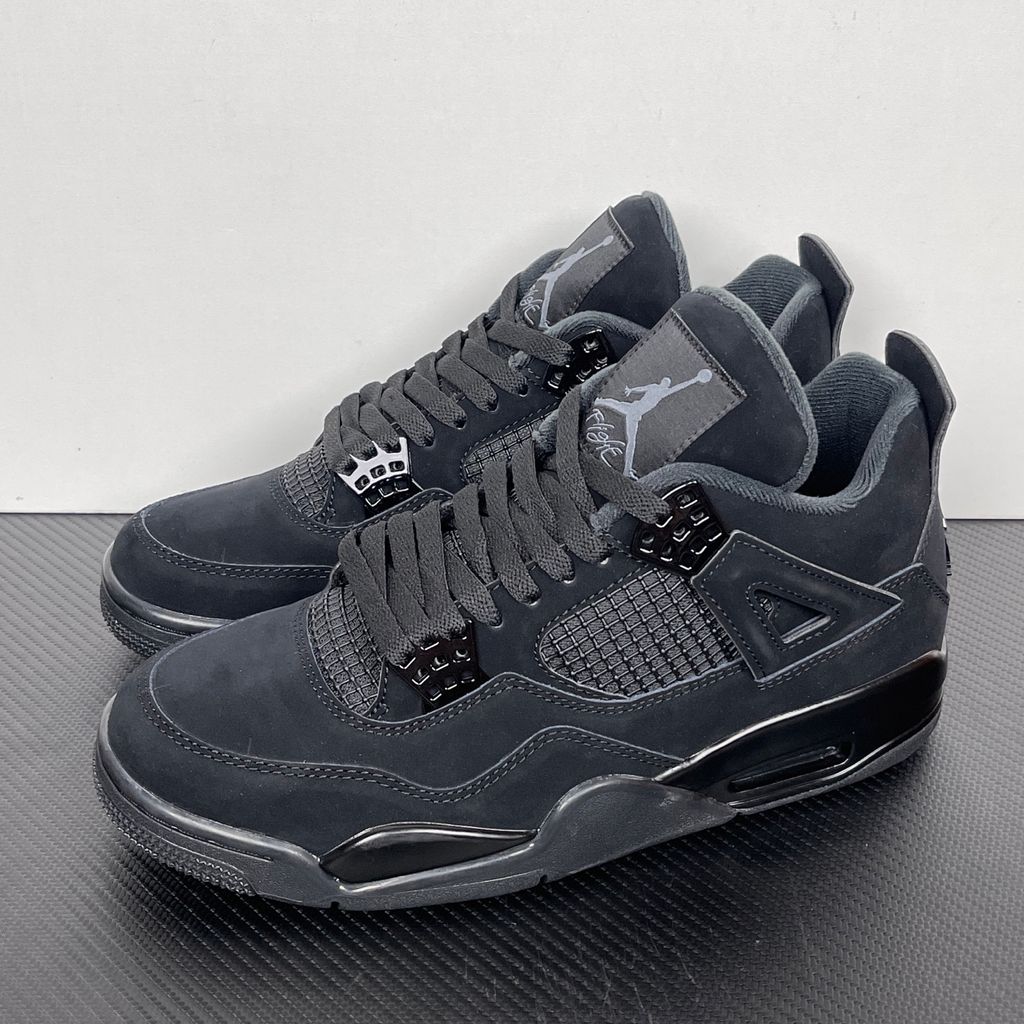 Side profile of the Air Jordan 4 Retro 'Black Cat' (2020) featuring a stealthy, monochromatic all-black nubuck suede upper, matching black mesh netting, matte wing eyelets, and a black midsole with a visible Air unit.  Product Description