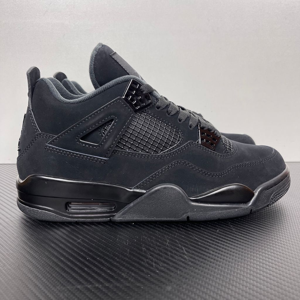 Side profile of the Air Jordan 4 Retro 'Black Cat' (2020) featuring a stealthy, monochromatic all-black nubuck suede upper, matching black mesh netting, matte wing eyelets, and a black midsole with a visible Air unit.  Product Description