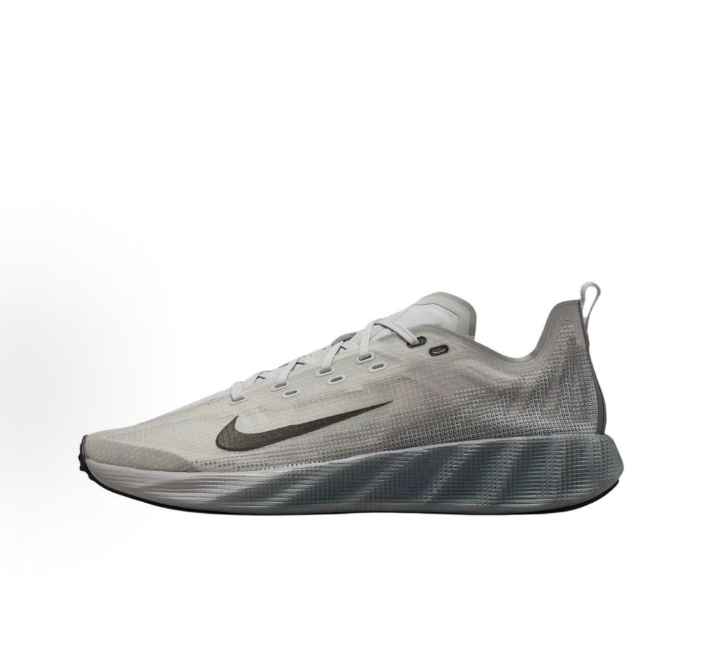 Side profile of the Nike Ava X sneaker in a clean Grey Fog and Black colorway, featuring a streamlined breathable mesh upper, sharp black Nike branding, and a sleek, lightweight cushioned midsole.