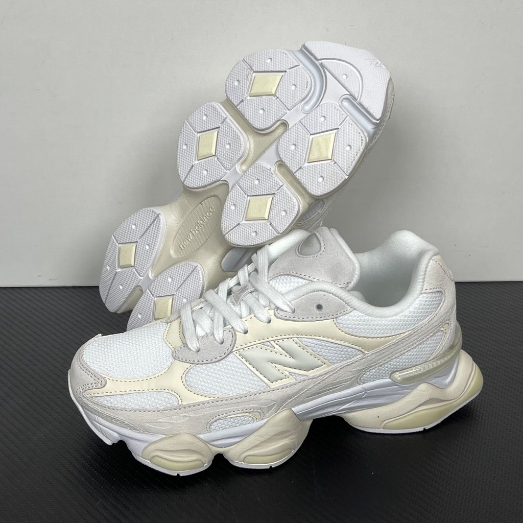 Side profile of the New Balance 9060 sneaker in a creamy Angora and Sea Salt colorway, featuring a chunky sculpted ABZORB midsole, premium suede overlays, a breathable mesh base, and the signature 'N' logo.