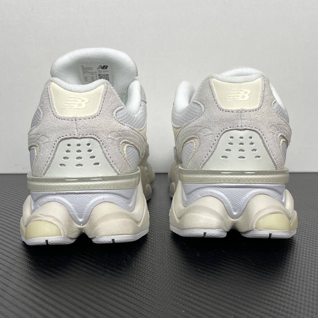 Side profile of the New Balance 9060 sneaker in a creamy Angora and Sea Salt colorway, featuring a chunky sculpted ABZORB midsole, premium suede overlays, a breathable mesh base, and the signature 'N' logo.