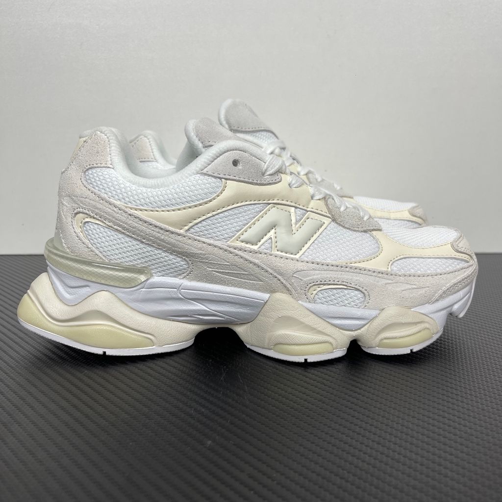 Side profile of the New Balance 9060 sneaker in a creamy Angora and Sea Salt colorway, featuring a chunky sculpted ABZORB midsole, premium suede overlays, a breathable mesh base, and the signature 'N' logo.