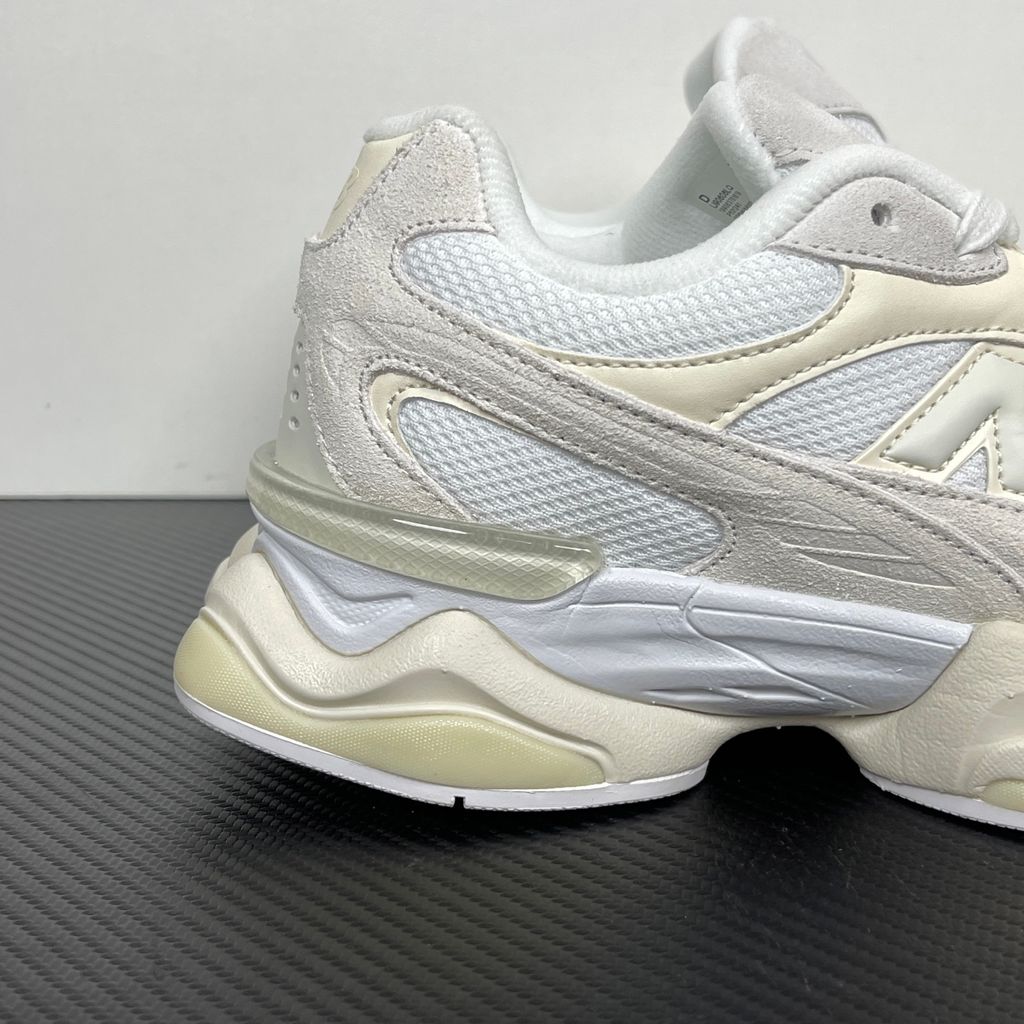 Side profile of the New Balance 9060 sneaker in a creamy Angora and Sea Salt colorway, featuring a chunky sculpted ABZORB midsole, premium suede overlays, a breathable mesh base, and the signature 'N' logo.