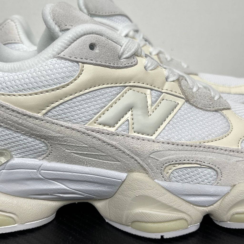 Side profile of the New Balance 9060 sneaker in a creamy Angora and Sea Salt colorway, featuring a chunky sculpted ABZORB midsole, premium suede overlays, a breathable mesh base, and the signature 'N' logo.
