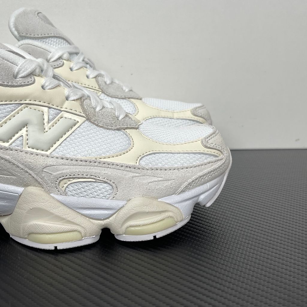 Side profile of the New Balance 9060 sneaker in a creamy Angora and Sea Salt colorway, featuring a chunky sculpted ABZORB midsole, premium suede overlays, a breathable mesh base, and the signature 'N' logo.
