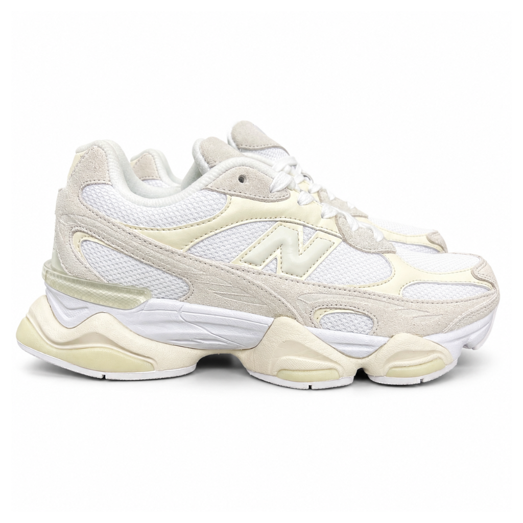 Side profile of the New Balance 9060 sneaker in a creamy Angora and Sea Salt colorway, featuring a chunky sculpted ABZORB midsole, premium suede overlays, a breathable mesh base, and the signature 'N' logo.