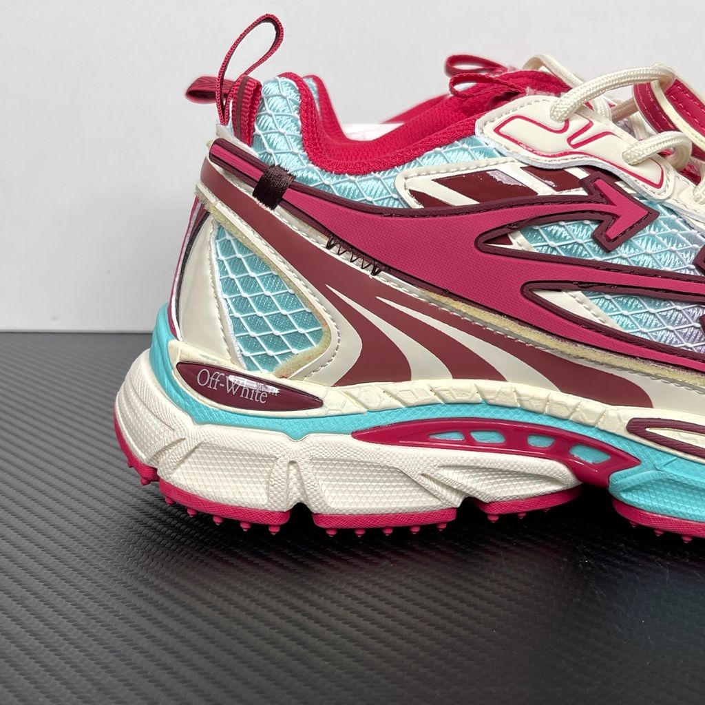 Side profile of the Off-White Be Right sneaker in a vibrant rose, burgundy, and light blue colorway, featuring a complex mesh upper, the signature Off-White arrow overlays, a matching pink zip-tie tag, and a chunky segmented midsole.