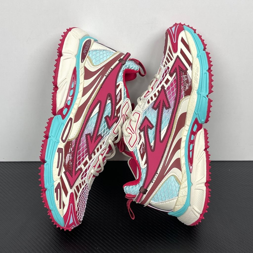 Side profile of the Off-White Be Right sneaker in a vibrant rose, burgundy, and light blue colorway, featuring a complex mesh upper, the signature Off-White arrow overlays, a matching pink zip-tie tag, and a chunky segmented midsole.