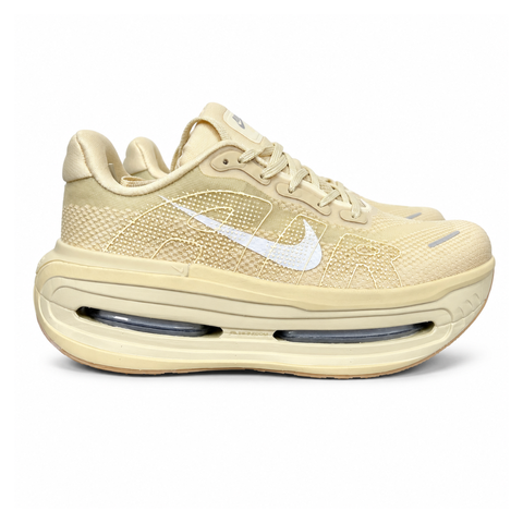 Side profile of the Nike Air Zoom Vomero Premium sneaker in a tonal Desert Khaki and Light Khaki colorway, featuring a complex layered upper of breathable mesh and premium suede overlays, resting on a chunky cushioned midsole.