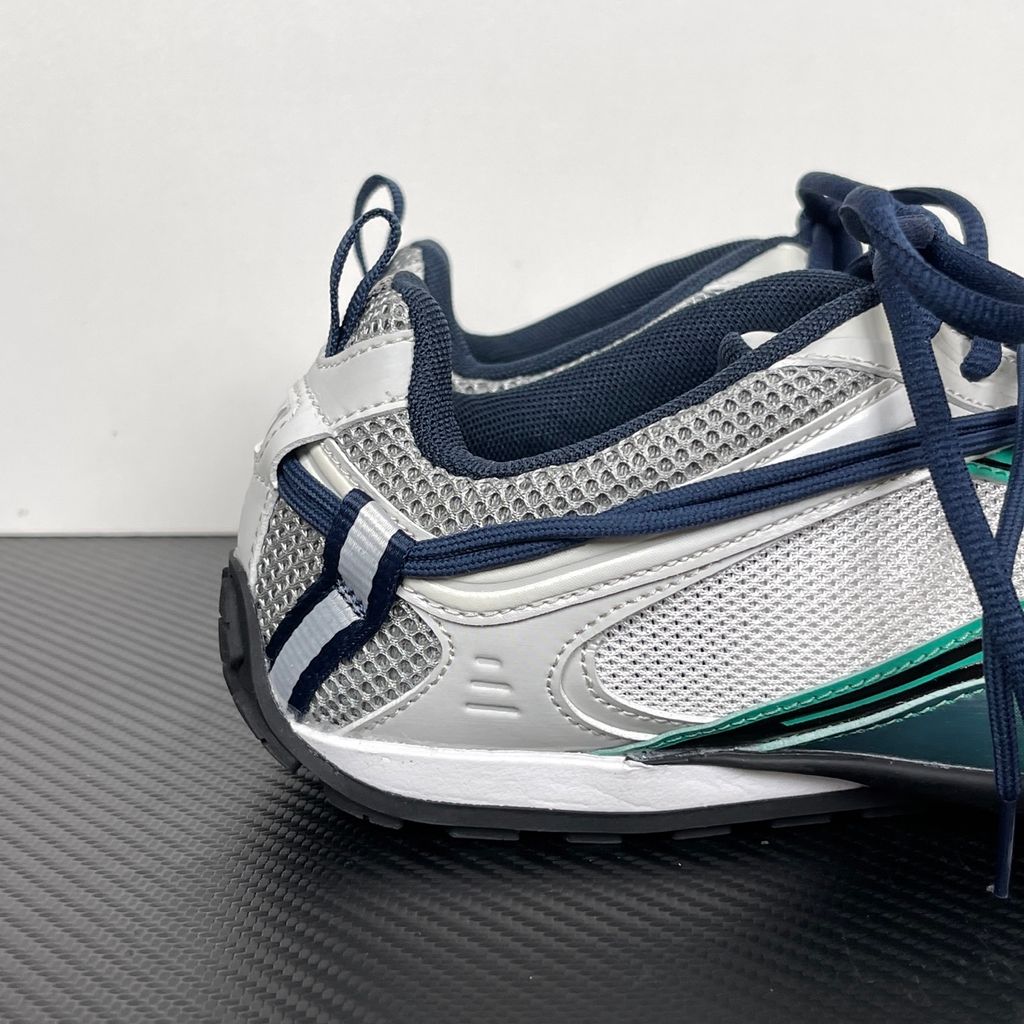 Side profile of the Balenciaga Radar sneaker in a light grey, neon green, and black colorway, featuring dynamic gradient lines across a layered mesh and synthetic upper, resting on an aggressive, chunky sculpted sole.