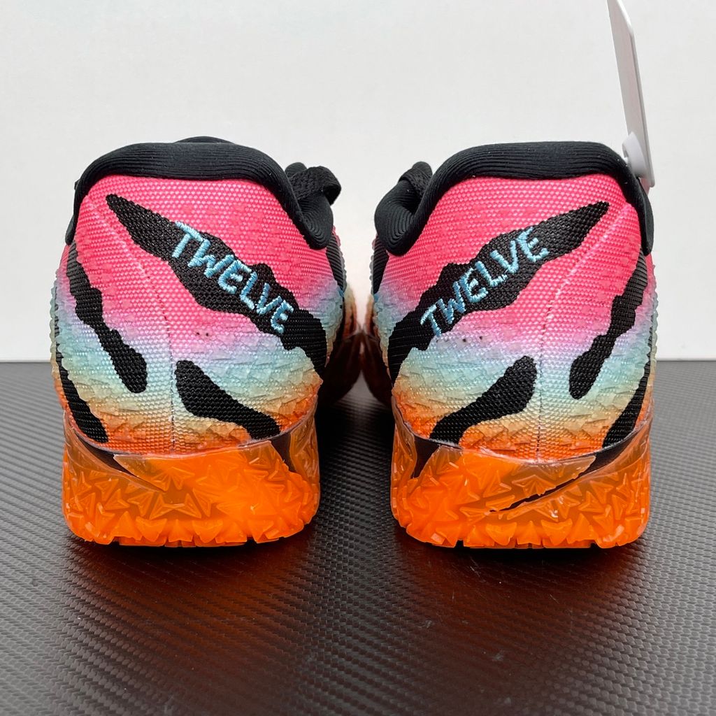 Side profile of the Nike Ja 3 'At Dawn' basketball sneaker, featuring a sleek, lightweight dark mesh upper contrasted by vibrant sunrise-inspired gradient accents, resting on a supportive midsole equipped with Zoom Air cushioning.