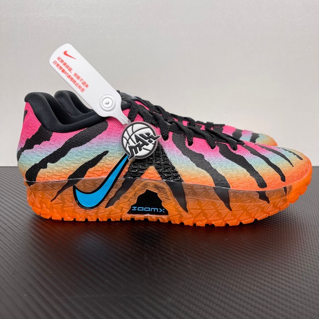 Side profile of the Nike Ja 3 'At Dawn' basketball sneaker, featuring a sleek, lightweight dark mesh upper contrasted by vibrant sunrise-inspired gradient accents, resting on a supportive midsole equipped with Zoom Air cushioning.