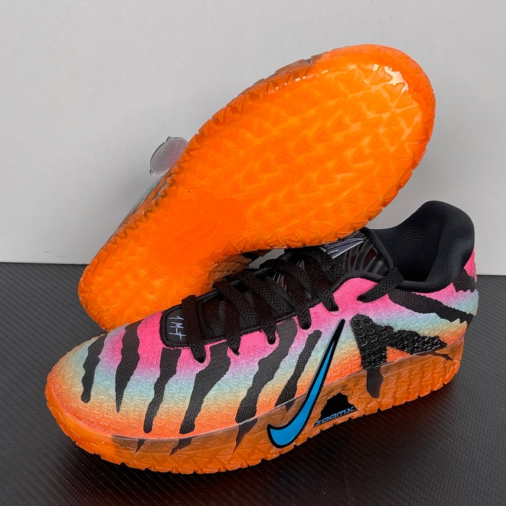 Side profile of the Nike Ja 3 'At Dawn' basketball sneaker, featuring a sleek, lightweight dark mesh upper contrasted by vibrant sunrise-inspired gradient accents, resting on a supportive midsole equipped with Zoom Air cushioning.