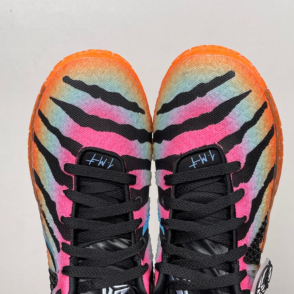 Side profile of the Nike Ja 3 'At Dawn' basketball sneaker, featuring a sleek, lightweight dark mesh upper contrasted by vibrant sunrise-inspired gradient accents, resting on a supportive midsole equipped with Zoom Air cushioning.