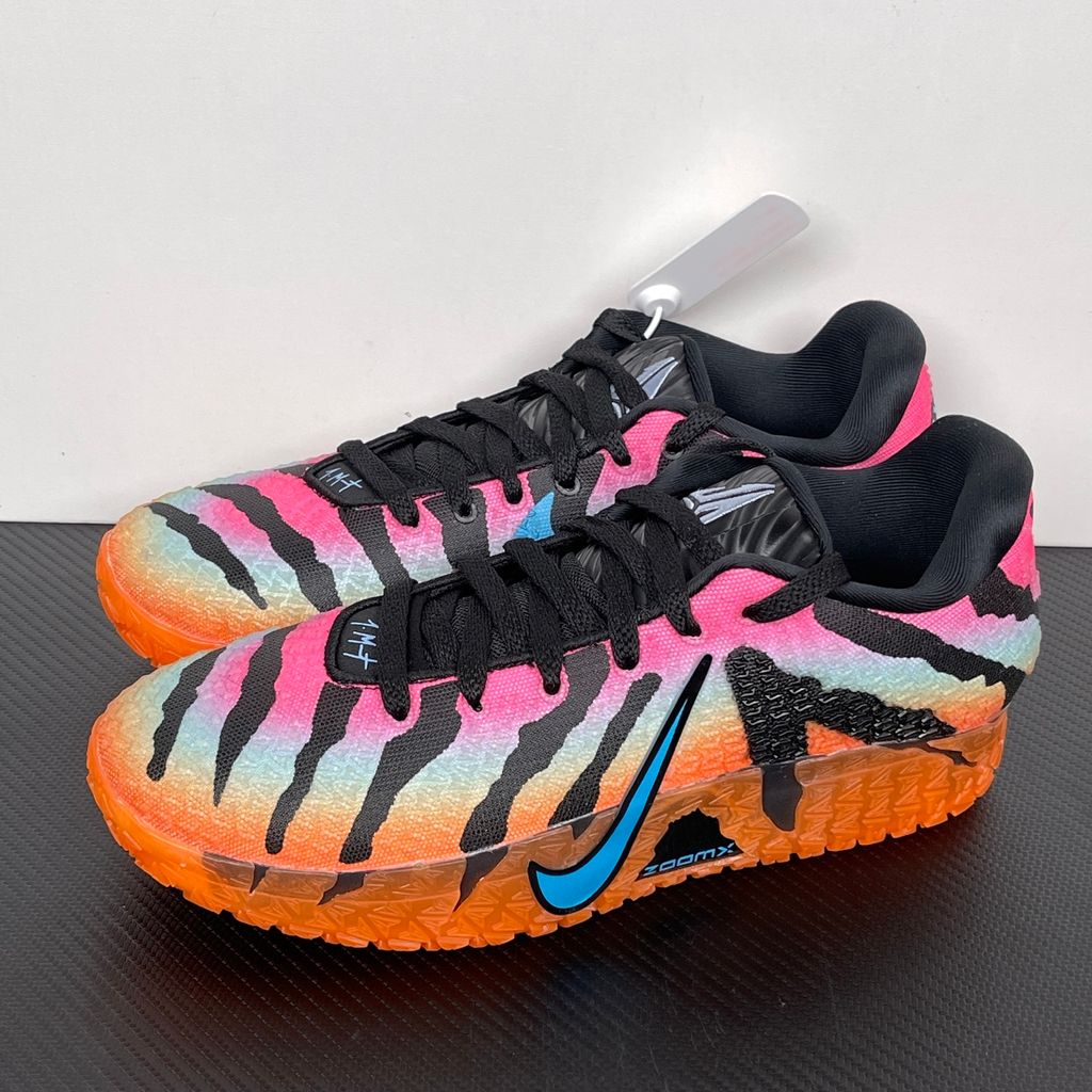 Side profile of the Nike Ja 3 'At Dawn' basketball sneaker, featuring a sleek, lightweight dark mesh upper contrasted by vibrant sunrise-inspired gradient accents, resting on a supportive midsole equipped with Zoom Air cushioning.