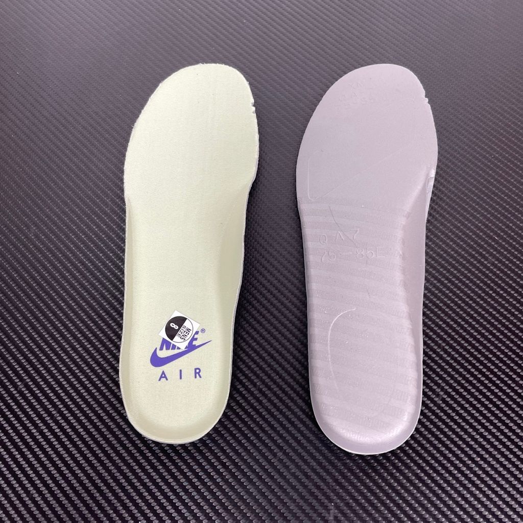 Side profile of the Nike Air Force 1 Low sneaker featuring a high-gloss patent leather upper in deep Mystic Navy, accented by vibrant Grape Ice purple detailing across the Swoosh and branding, resting on a classic white midsole.