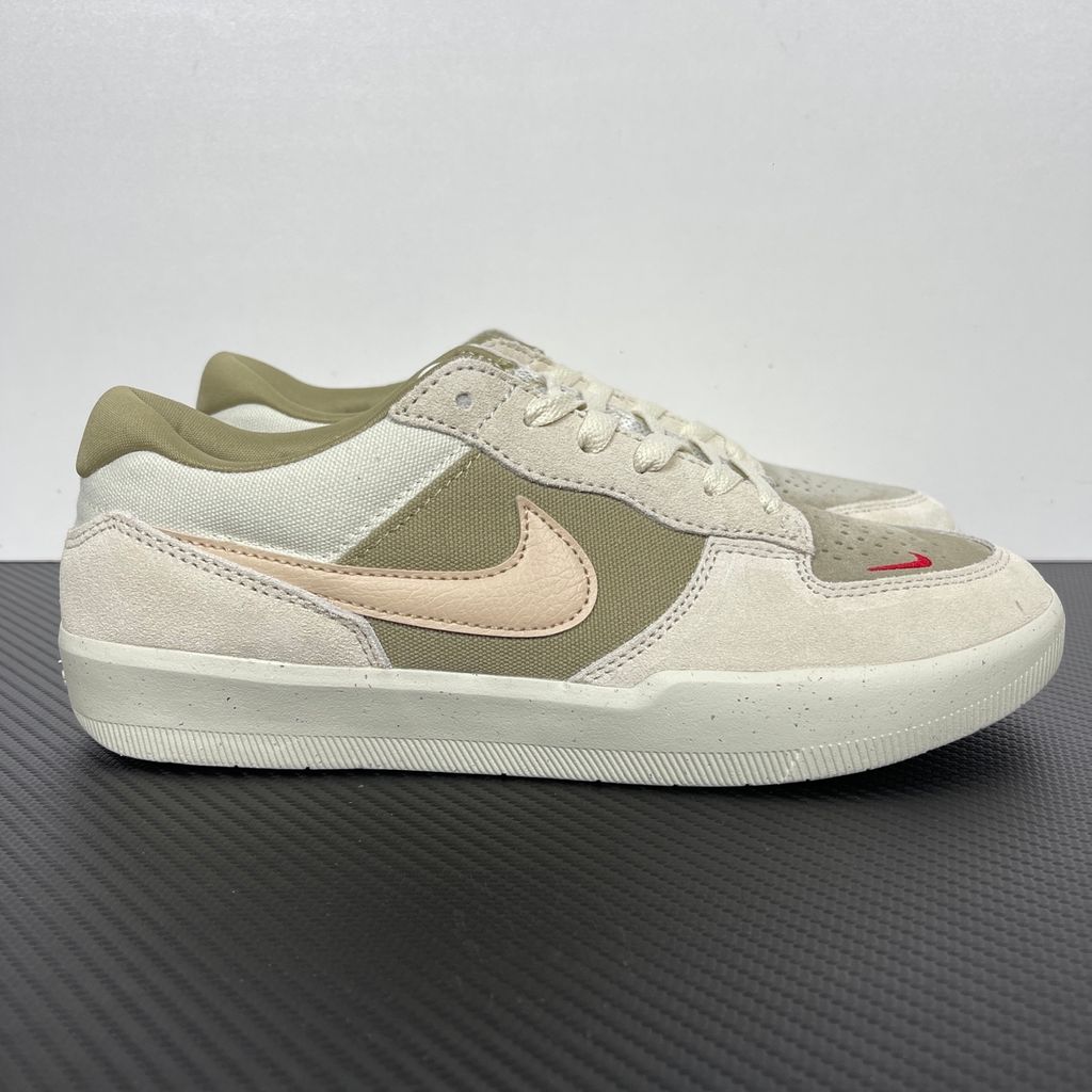 Side profile of the Nike SB Force 58 skate shoe featuring a creamy Coconut Milk canvas and suede upper, accented by a Neutral Olive green Swoosh and detailing, resting on a crisp white sole with a flexible tri-star tread.