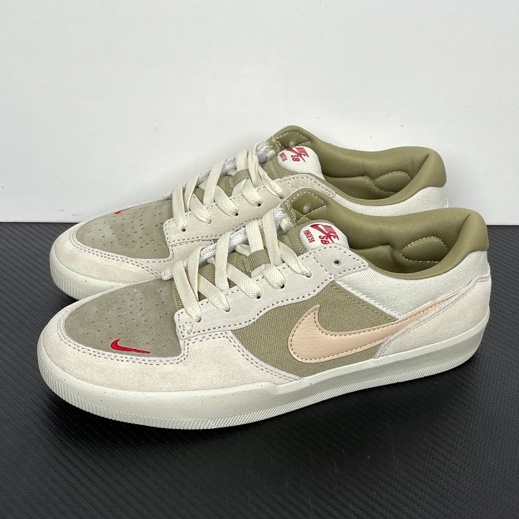 Side profile of the Nike SB Force 58 skate shoe featuring a creamy Coconut Milk canvas and suede upper, accented by a Neutral Olive green Swoosh and detailing, resting on a crisp white sole with a flexible tri-star tread.