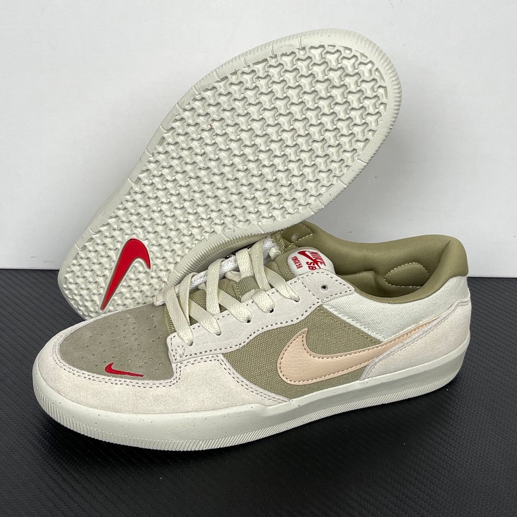 Side profile of the Nike SB Force 58 skate shoe featuring a creamy Coconut Milk canvas and suede upper, accented by a Neutral Olive green Swoosh and detailing, resting on a crisp white sole with a flexible tri-star tread.