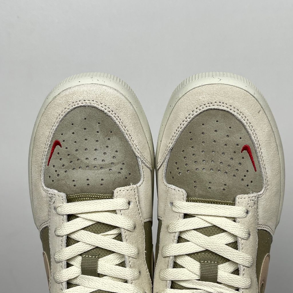 Side profile of the Nike SB Force 58 skate shoe featuring a creamy Coconut Milk canvas and suede upper, accented by a Neutral Olive green Swoosh and detailing, resting on a crisp white sole with a flexible tri-star tread.