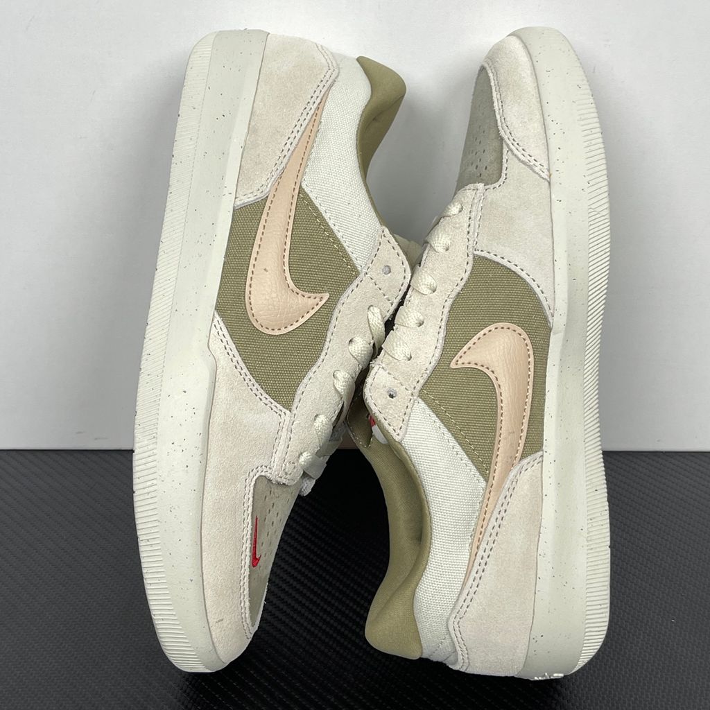 Side profile of the Nike SB Force 58 skate shoe featuring a creamy Coconut Milk canvas and suede upper, accented by a Neutral Olive green Swoosh and detailing, resting on a crisp white sole with a flexible tri-star tread.