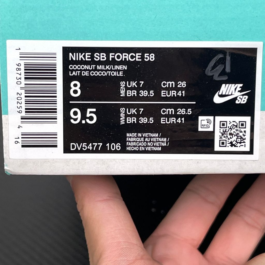 Side profile of the Nike SB Force 58 skate shoe featuring a creamy Coconut Milk canvas and suede upper, accented by a Neutral Olive green Swoosh and detailing, resting on a crisp white sole with a flexible tri-star tread.