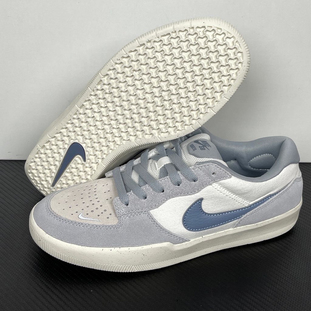 Side profile of the Nike SB Force 58 skate shoe featuring a creamy Coconut Milk canvas and suede upper, accented by a Neutral Olive green Swoosh and detailing, resting on a crisp white sole with a flexible tri-star tread.