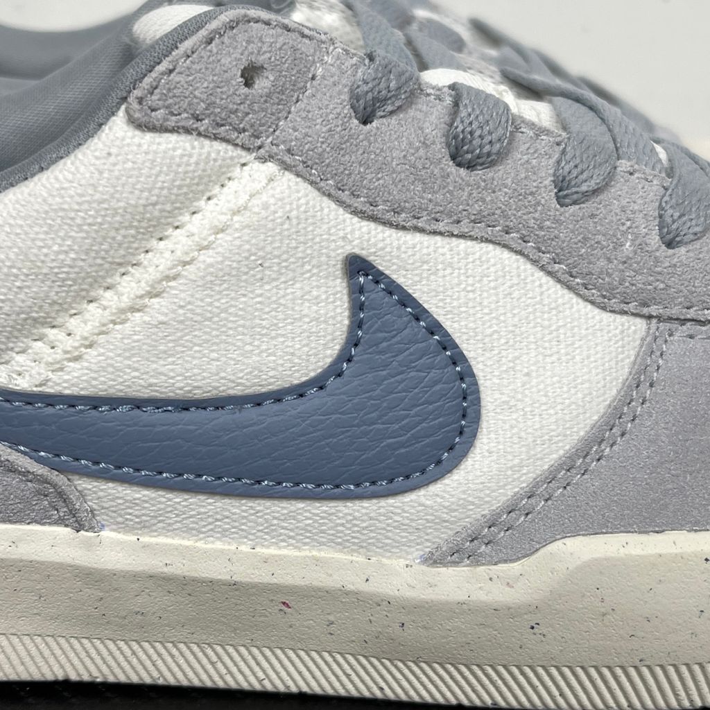 Side profile of the Nike SB Force 58 skate shoe featuring a creamy Coconut Milk canvas and suede upper, accented by a Neutral Olive green Swoosh and detailing, resting on a crisp white sole with a flexible tri-star tread.