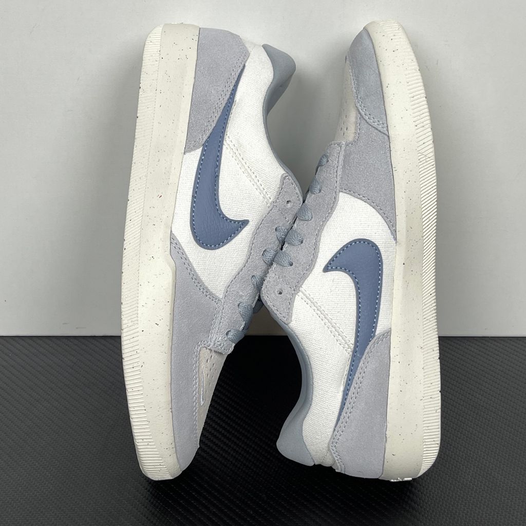 Side profile of the Nike SB Force 58 skate shoe featuring a creamy Coconut Milk canvas and suede upper, accented by a Neutral Olive green Swoosh and detailing, resting on a crisp white sole with a flexible tri-star tread.