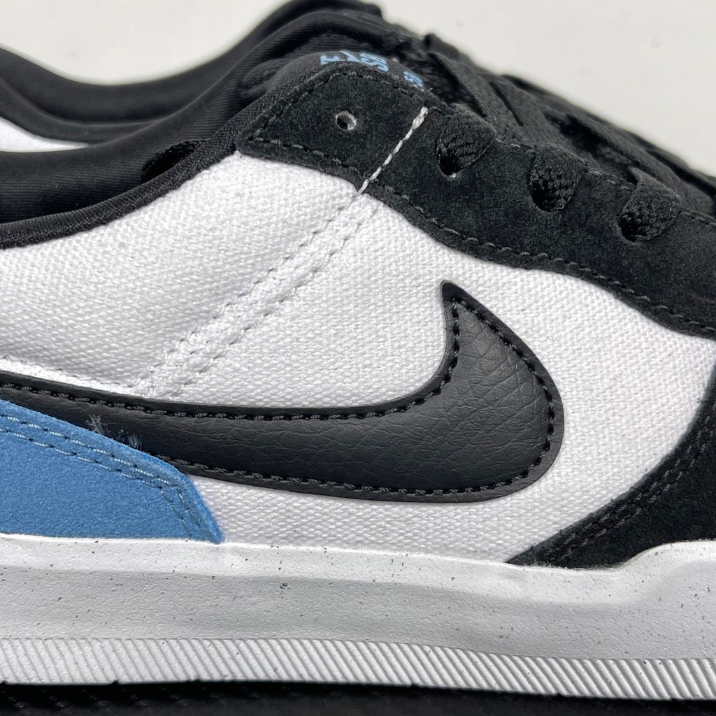 Side profile of the Nike SB Force 58 skate shoe featuring a vibrant Dutch Blue canvas and suede upper, accented by a crisp white Swoosh and detailing, resting on a white sole with a flexible tri-star tread.