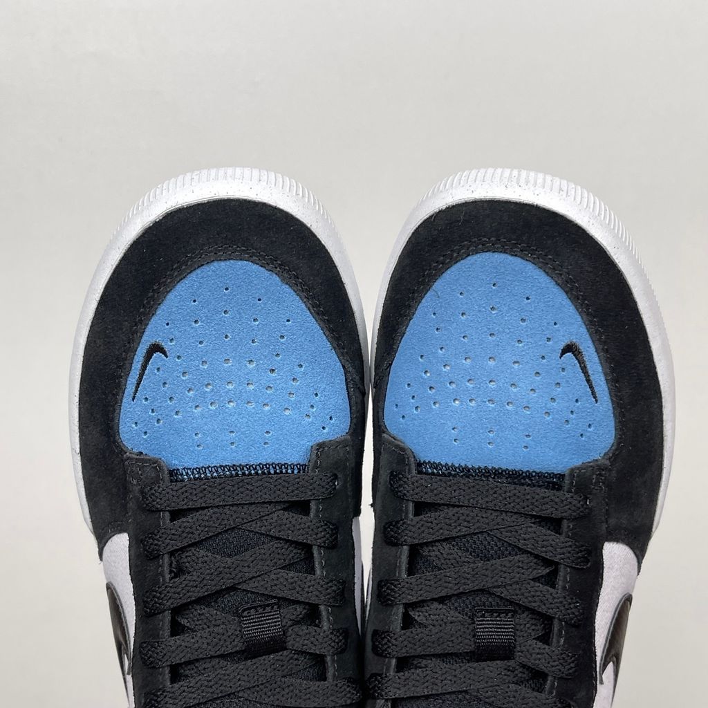 Side profile of the Nike SB Force 58 skate shoe featuring a vibrant Dutch Blue canvas and suede upper, accented by a crisp white Swoosh and detailing, resting on a white sole with a flexible tri-star tread.