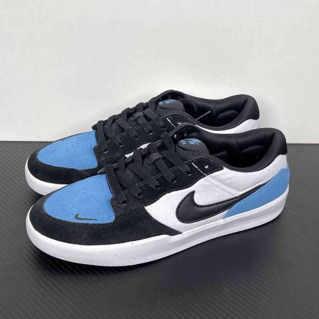 Side profile of the Nike SB Force 58 skate shoe featuring a vibrant Dutch Blue canvas and suede upper, accented by a crisp white Swoosh and detailing, resting on a white sole with a flexible tri-star tread.