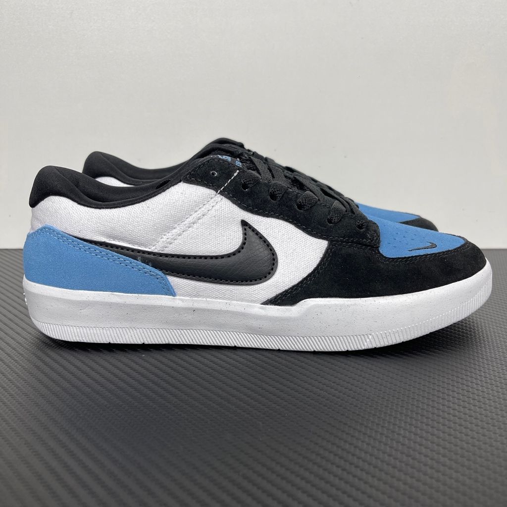 Side profile of the Nike SB Force 58 skate shoe featuring a vibrant Dutch Blue canvas and suede upper, accented by a crisp white Swoosh and detailing, resting on a white sole with a flexible tri-star tread.