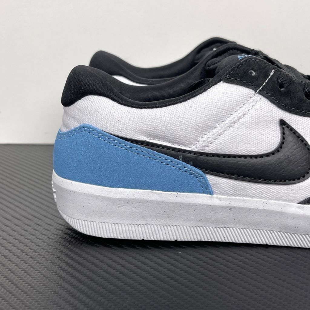 Side profile of the Nike SB Force 58 skate shoe featuring a vibrant Dutch Blue canvas and suede upper, accented by a crisp white Swoosh and detailing, resting on a white sole with a flexible tri-star tread.