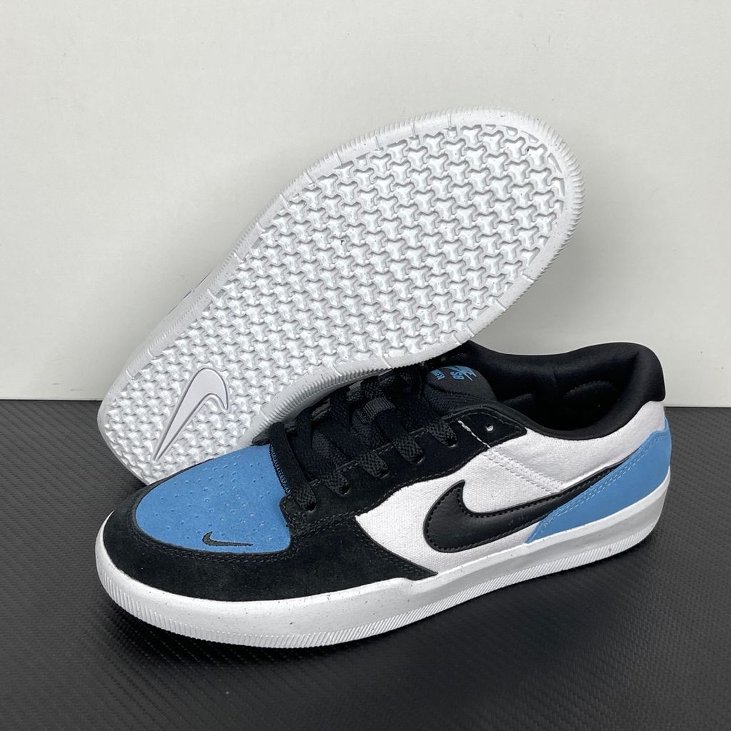 Side profile of the Nike SB Force 58 skate shoe featuring a vibrant Dutch Blue canvas and suede upper, accented by a crisp white Swoosh and detailing, resting on a white sole with a flexible tri-star tread.