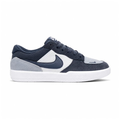 Side profile of the Nike SB Force 58 skate shoe featuring a soft Light Armory Blue canvas and suede upper, accented by a deep Thunder Blue Swoosh and detailing, resting on a crisp white sole with a flexible tri-star tread.