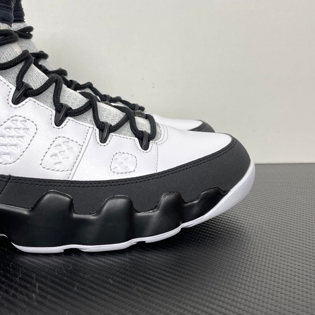Side profile of the Air Jordan 9 Retro OG 'Space Jam' (2026) sneaker featuring a crisp white leather upper, a sleek black mudguard and midsole, True Red branding on the heel, and a classic sculpted rubber outsole.