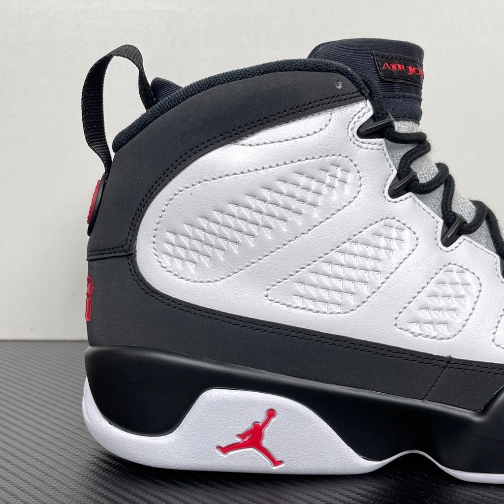 Side profile of the Air Jordan 9 Retro OG 'Space Jam' (2026) sneaker featuring a crisp white leather upper, a sleek black mudguard and midsole, True Red branding on the heel, and a classic sculpted rubber outsole.
