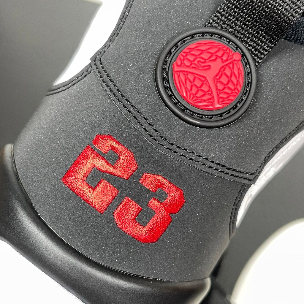 Side profile of the Air Jordan 9 Retro OG 'Space Jam' (2026) sneaker featuring a crisp white leather upper, a sleek black mudguard and midsole, True Red branding on the heel, and a classic sculpted rubber outsole.