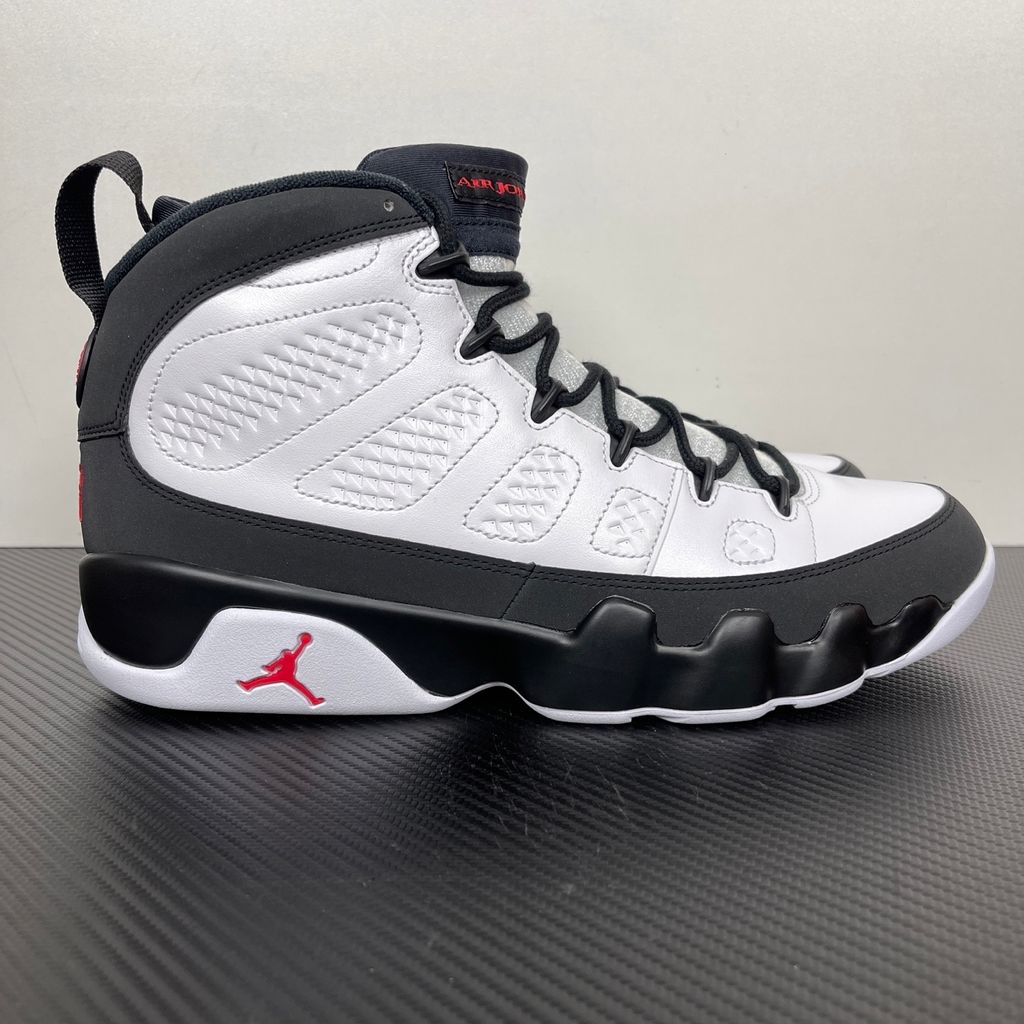 Side profile of the Air Jordan 9 Retro OG 'Space Jam' (2026) sneaker featuring a crisp white leather upper, a sleek black mudguard and midsole, True Red branding on the heel, and a classic sculpted rubber outsole.