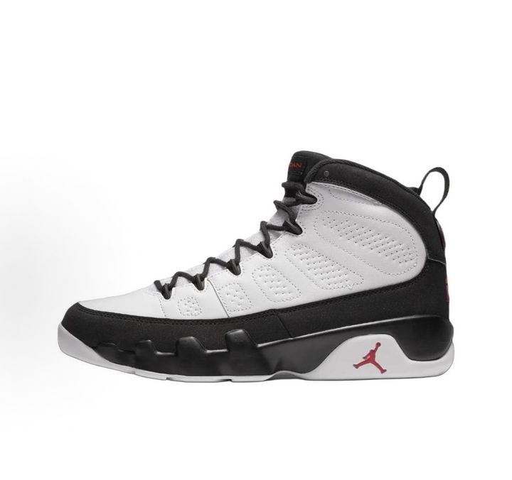 Side profile of the Air Jordan 9 Retro OG 'Space Jam' (2026) sneaker featuring a crisp white leather upper, a sleek black mudguard and midsole, True Red branding on the heel, and a classic sculpted rubber outsole.