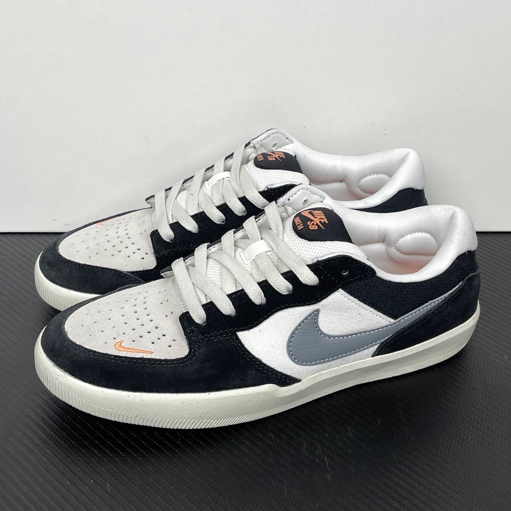 Side profile of the Nike SB Force 58 skate shoe featuring a sleek Black suede and Cool Gray canvas upper, accented by a crisp Mountain Peak White Swoosh and detailing, resting on a white sole with a flexible tri-star tread.