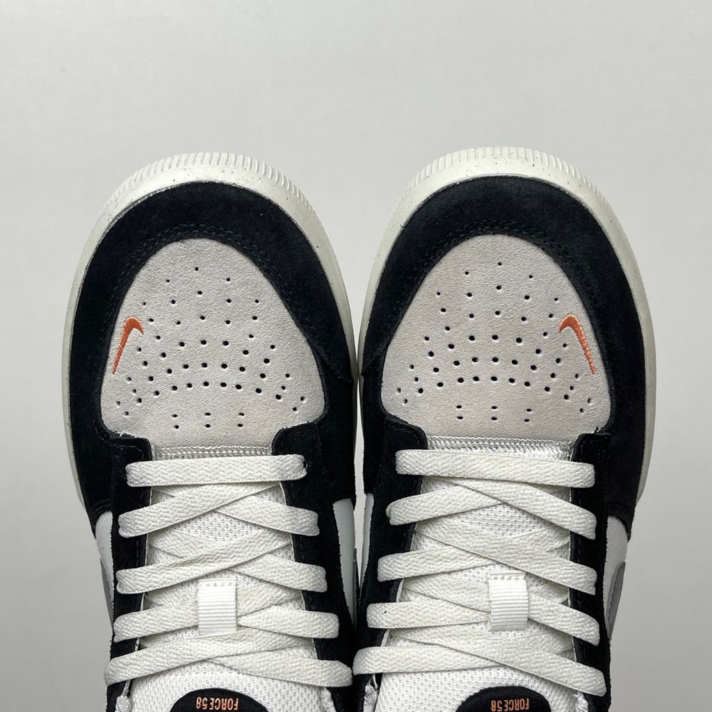 Side profile of the Nike SB Force 58 skate shoe featuring a sleek Black suede and Cool Gray canvas upper, accented by a crisp Mountain Peak White Swoosh and detailing, resting on a white sole with a flexible tri-star tread.