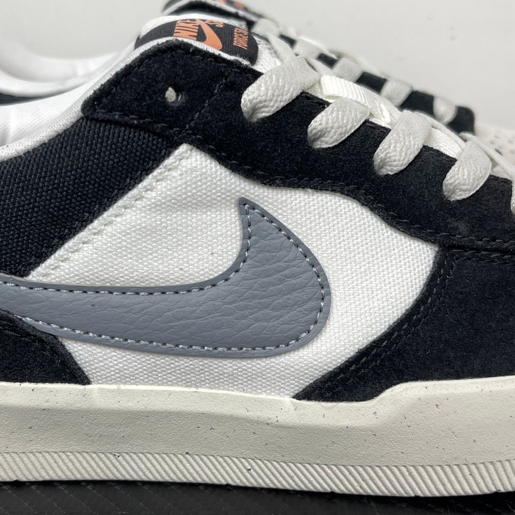 Side profile of the Nike SB Force 58 skate shoe featuring a sleek Black suede and Cool Gray canvas upper, accented by a crisp Mountain Peak White Swoosh and detailing, resting on a white sole with a flexible tri-star tread.