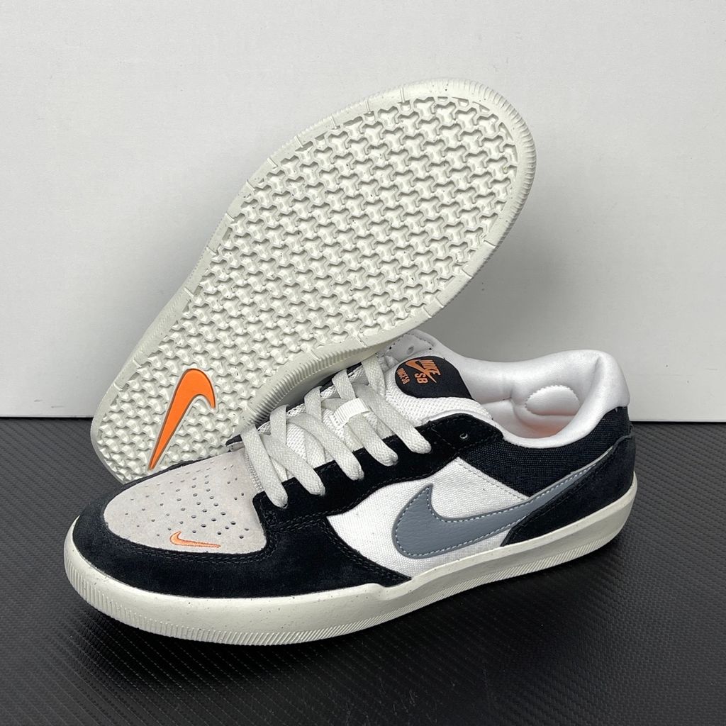 Side profile of the Nike SB Force 58 skate shoe featuring a sleek Black suede and Cool Gray canvas upper, accented by a crisp Mountain Peak White Swoosh and detailing, resting on a white sole with a flexible tri-star tread.