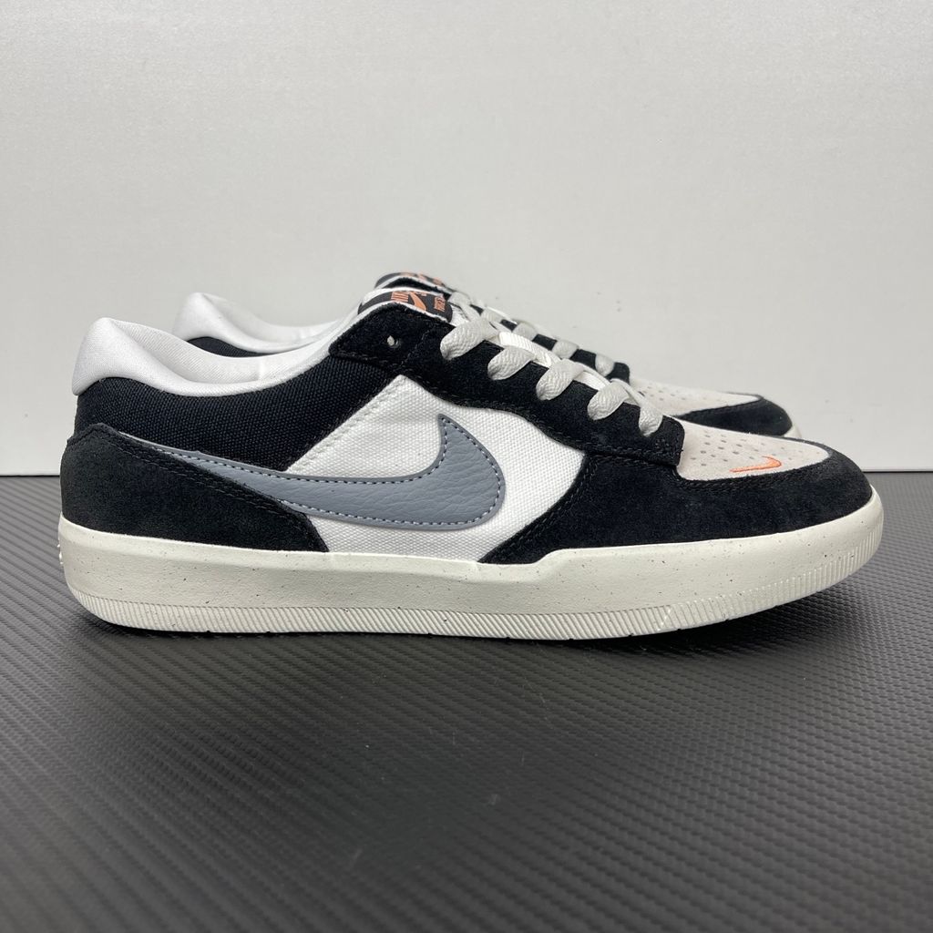 Side profile of the Nike SB Force 58 skate shoe featuring a sleek Black suede and Cool Gray canvas upper, accented by a crisp Mountain Peak White Swoosh and detailing, resting on a white sole with a flexible tri-star tread.